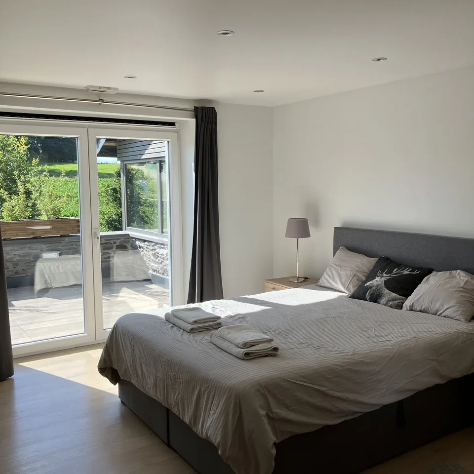 The north bedroom of Pegasus I: a double bed and French windows onto the terrace.